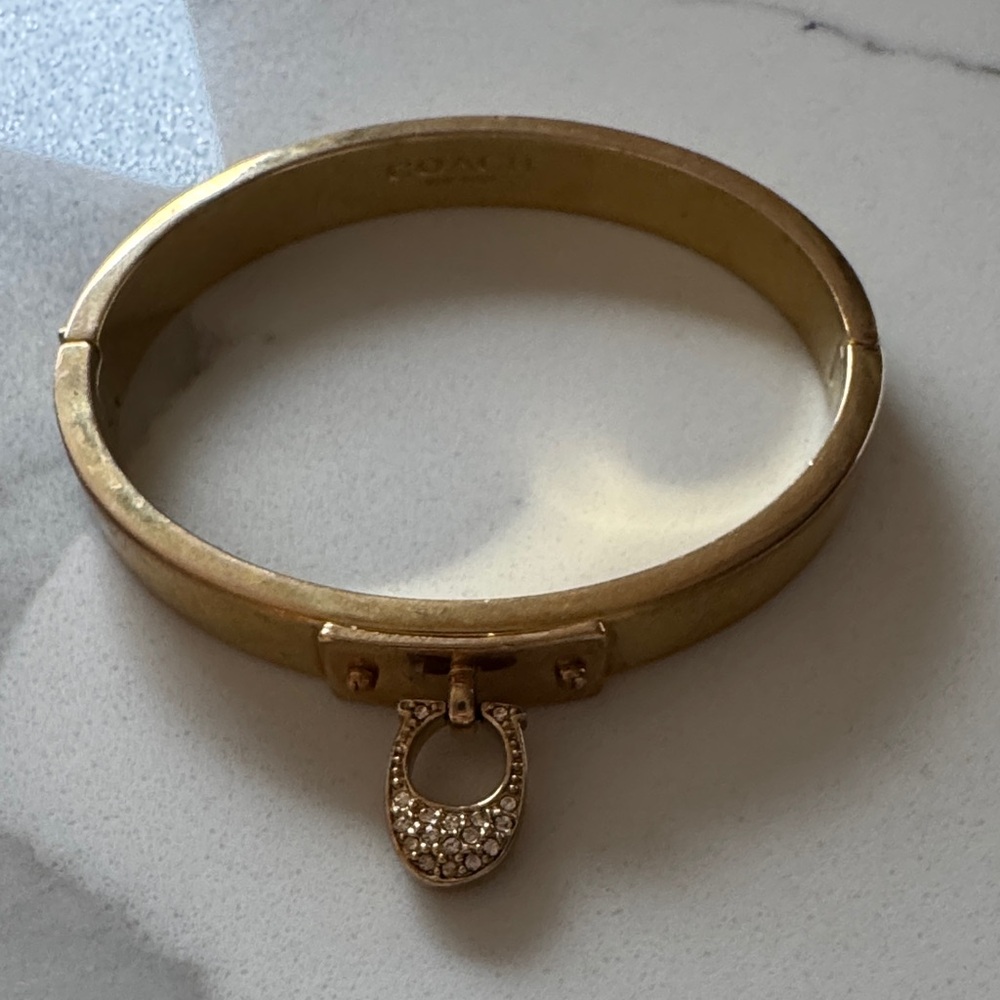 Coach Gold Bracelet with Crystal “C logo” Charm.